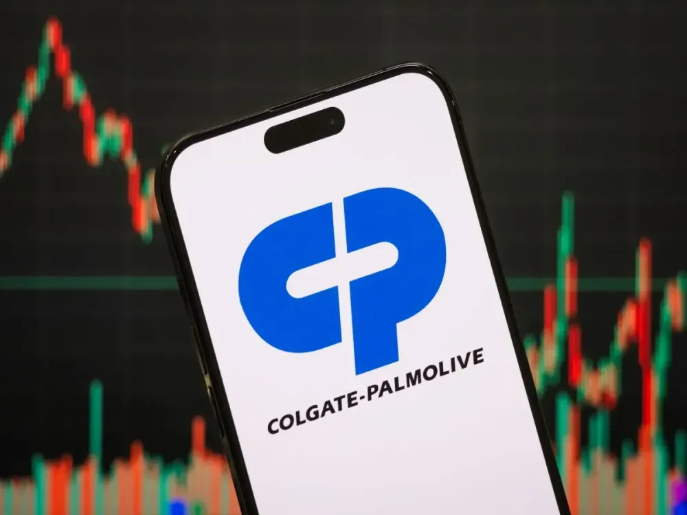 In this photo illustration, the logo of Colgate-Palmolive Company is displayed on a smartphone screen, with stock market candlestick charts in the background, n Chongqing, China. (Photo illustration by Cheng Xin/Getty Images)