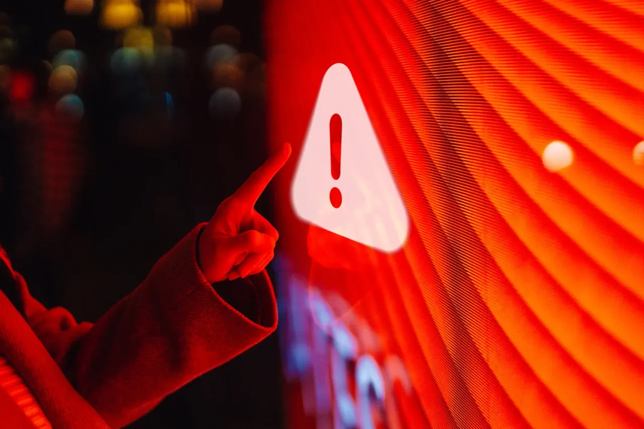 Representative image of a woman touching an illuminated warning sign. (Photo by Oscar Wong/Getty Images)