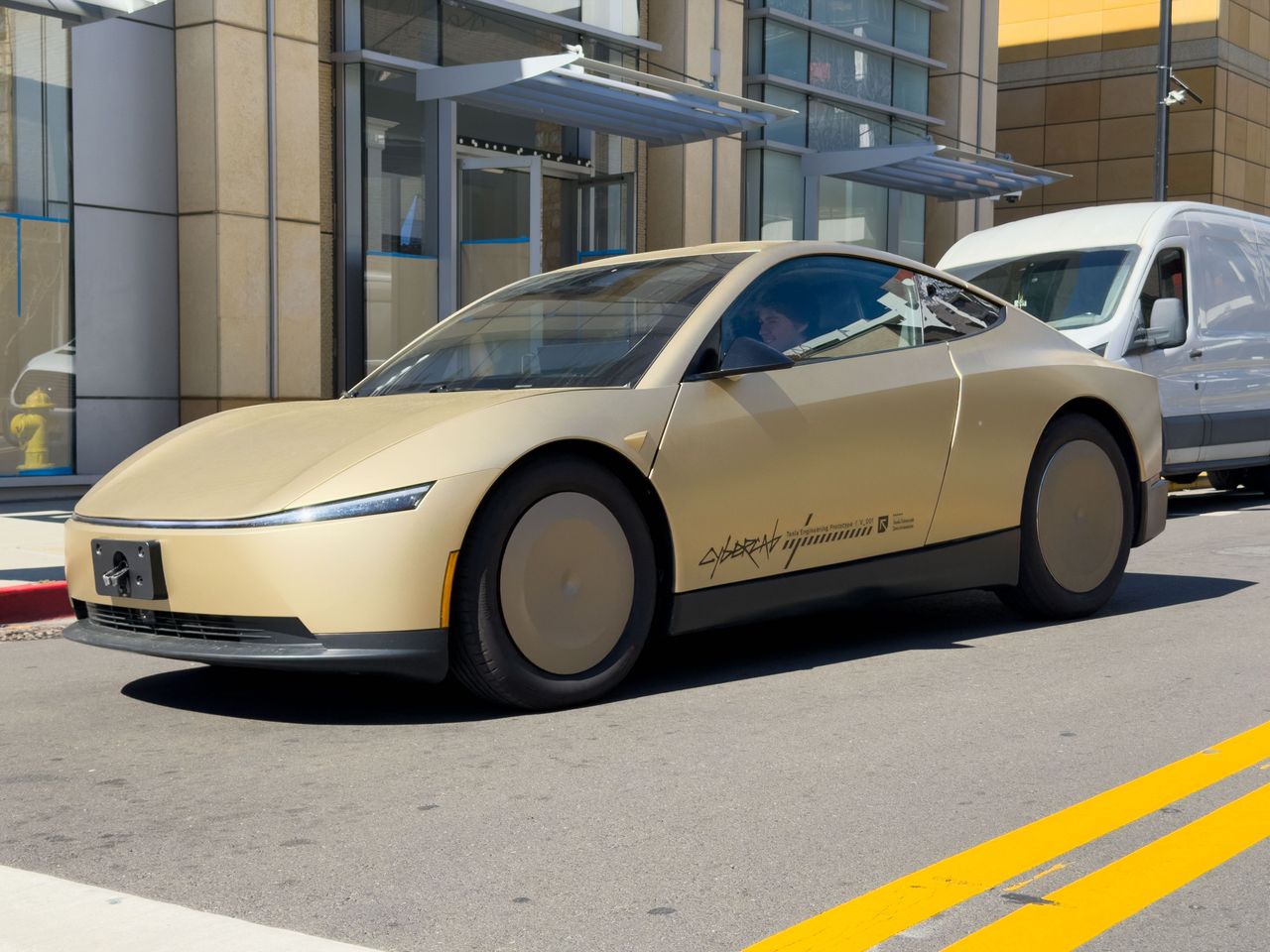 A test car of the Tesla robotaxi Cybercab is on the road. The vehicles will not have a steering wheel or pedals when they are launched on the market. (Photo by Andrej Sokolow/picture alliance via Getty Images)