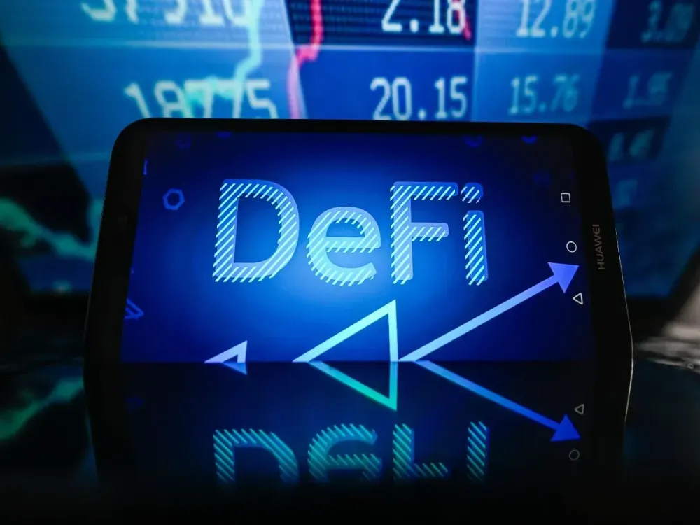 In this photo illustration, a DeFi logo is displayed on a smartphone with stock market percentages in the background. (Photo Illustration by Omar Marques/SOPA Images/LightRocket via Getty Images)