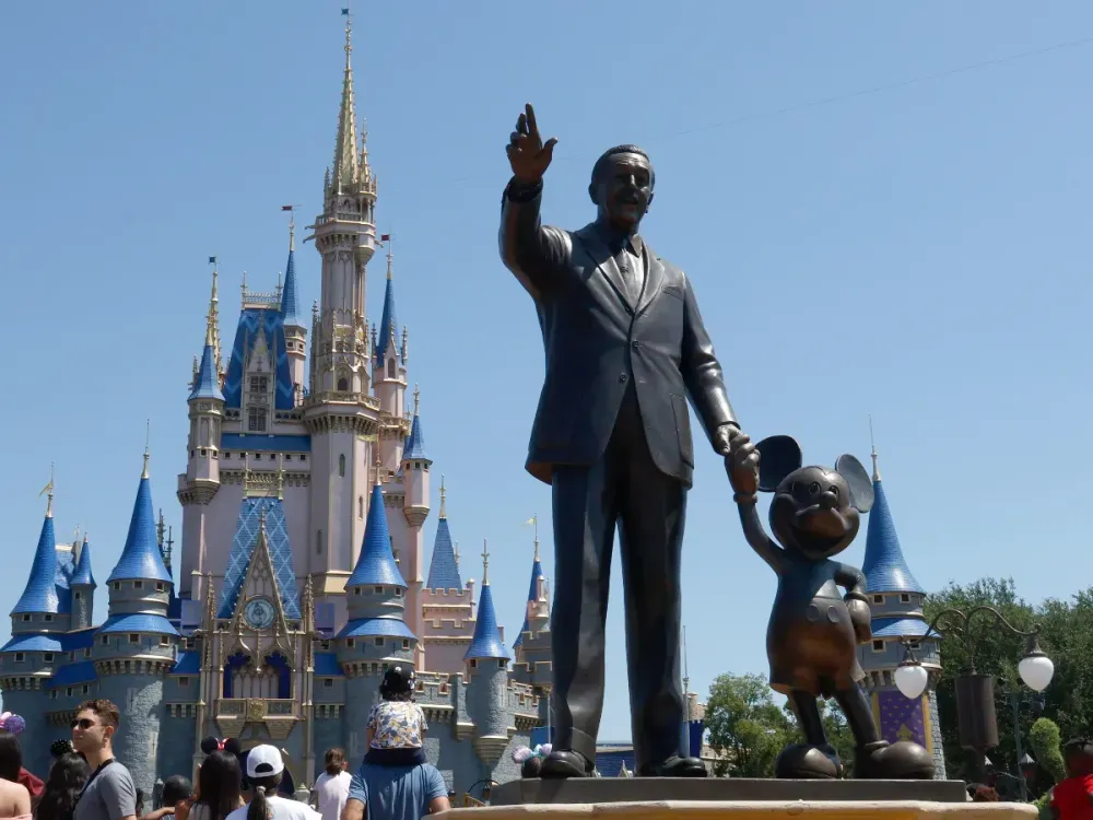  A statue of Walt Disney and Mickey Mouse stands in a garden in front of Cinderella's Castle at the Magic Kingdom Park at Walt Disney World on May 31, 2024, in Orlando, Florida. (Photo by Gary Hershorn/Getty Images)