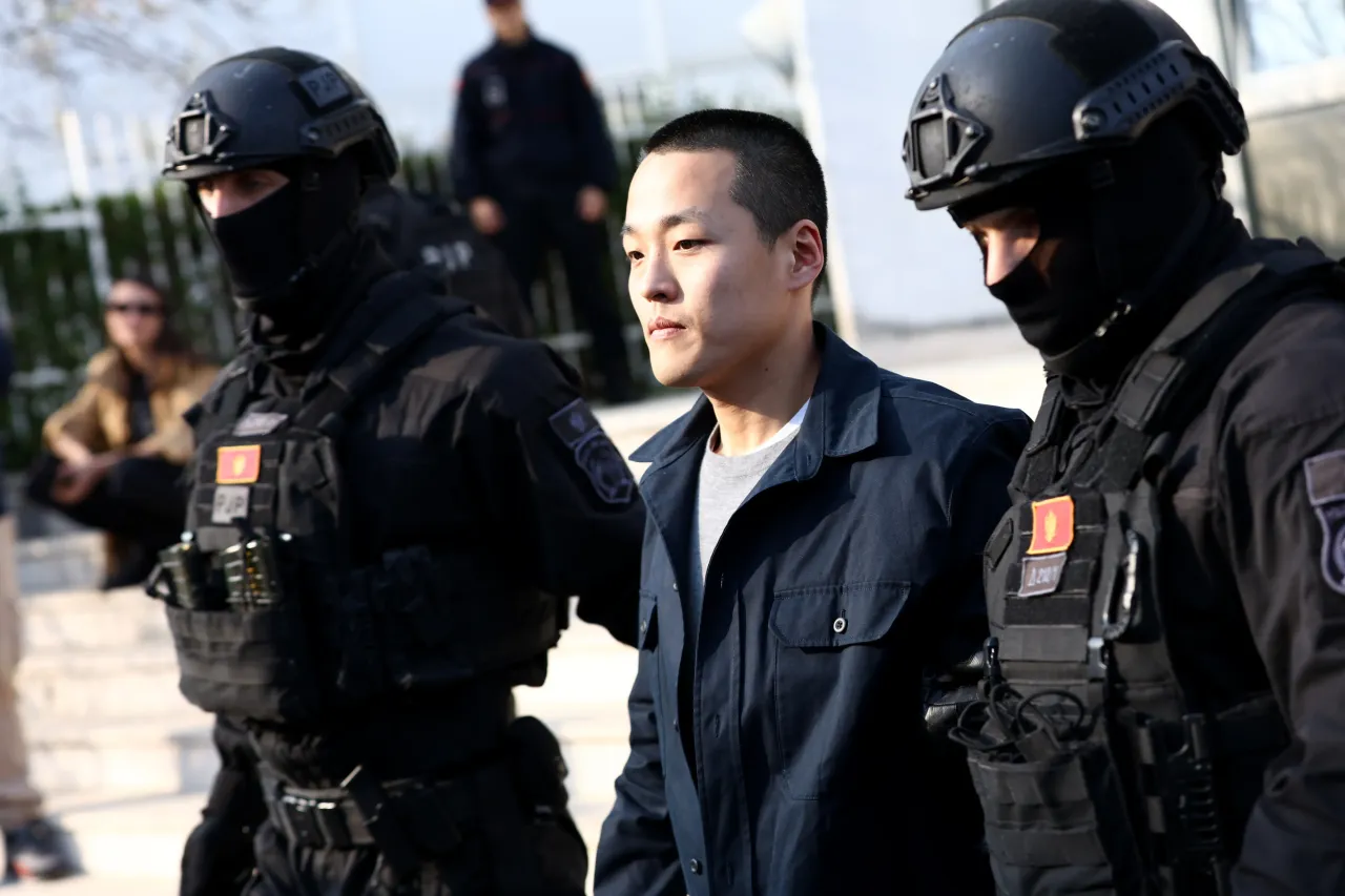 Police officers escort Do Kwon after he served sentence in prison for document forgery on March 23, 2024 in Podgorica, Montenegro. (Photo by Filip Filipovic/Getty Images)