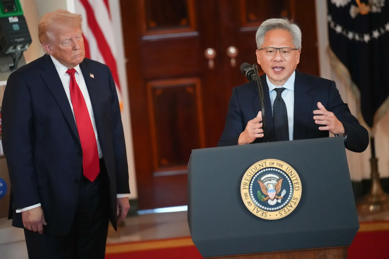 U.S. President Donald Trump listens as Nvidia CEO Jensen Huang speaks in the Cross Hall of the White House during an event in April