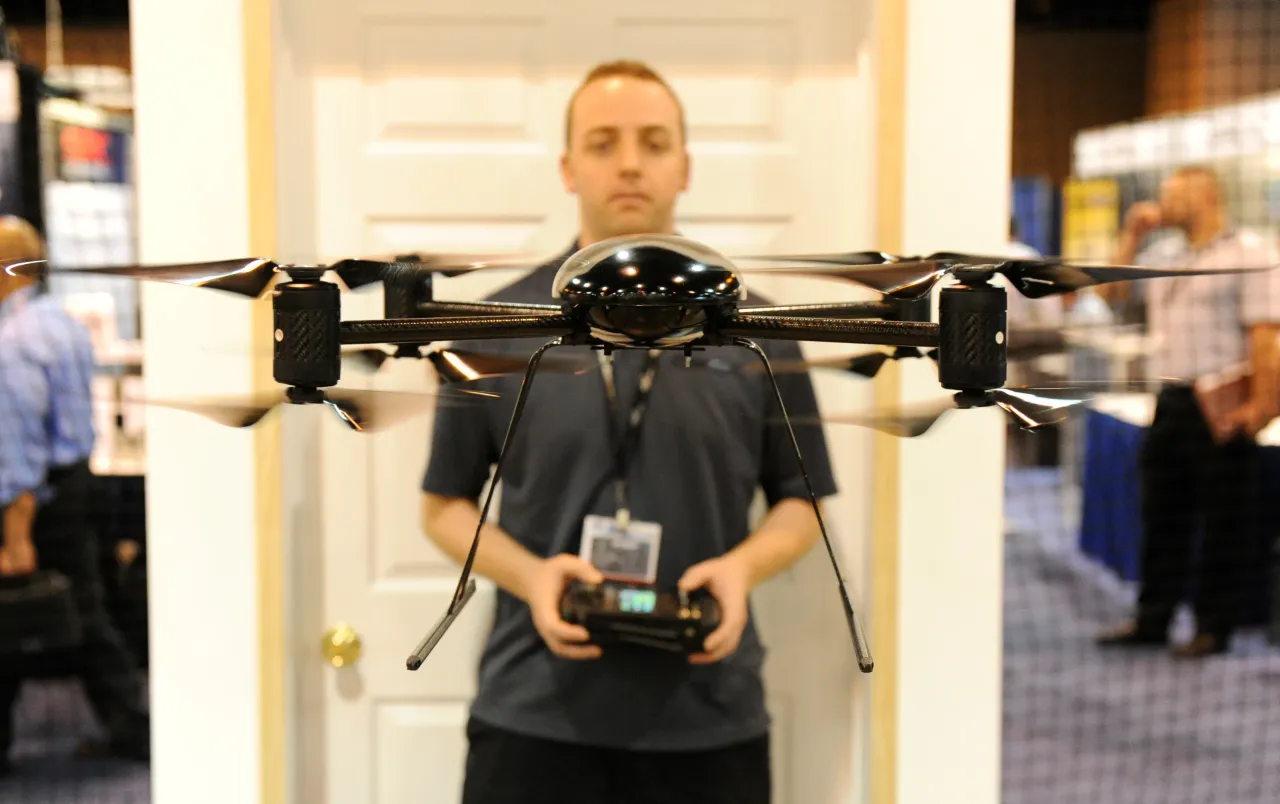 A designer and engineer for Draganfly Innovations maneuvers a Draganflyer X8 miniature helicopter during a demonstration at the AUVSI's Unmanned Systems North America 2010. (Photo By Andy Cross/The Denver Post via Getty Images)
