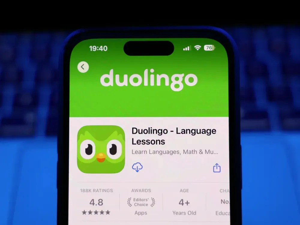 A laptop keyboard and Duolingo on App Store displayed on a phone screen are seen in this illustration photo. (Photo by Jakub Porzycki/NurPhoto via Getty Images)