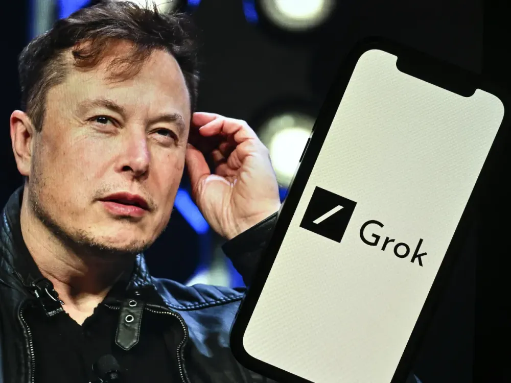 In this photo illustration, Elon Musk's photo is displayed in front of Grok logo on a phone screen, in Ankara, Turkiye on November 7, 2023. (Photo by Muhammed Selim Korkutata/Anadolu via Getty Images)