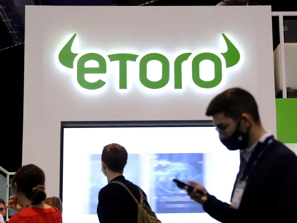The Etoro logo is seen during the 2021 Web Summit in Lisbon, Portugal on November 4, 2021. (Photo by Pedro Fiúza/NurPhoto via Getty Images)
