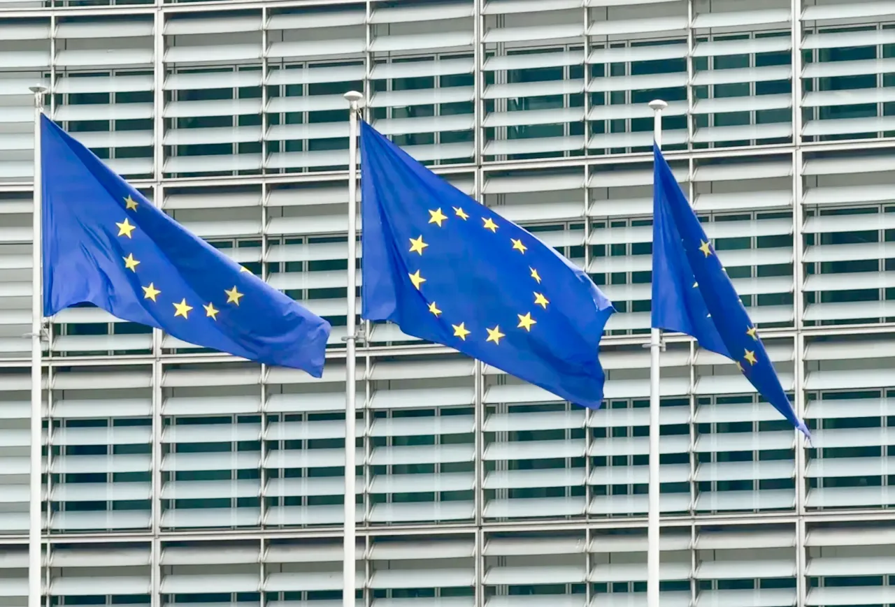 Three flags of the European Union fly in front of the EU Commission building. (Photo by Alicia Windzio/picture alliance via Getty Images)