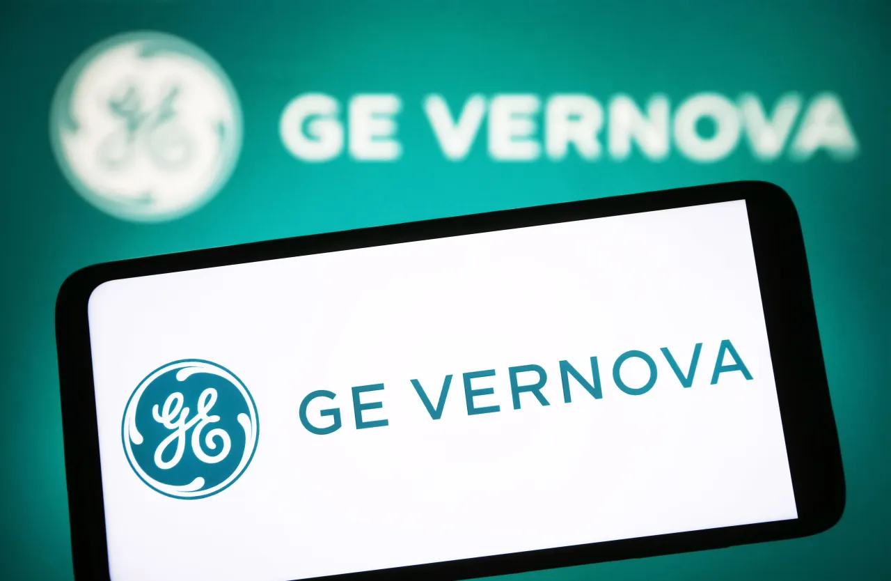 In this photo illustration, the GE Vernova logo is seen on a smartphone and in the background. (Photo Illustration by Pavlo Gonchar/SOPA Images/LightRocket via Getty Images)