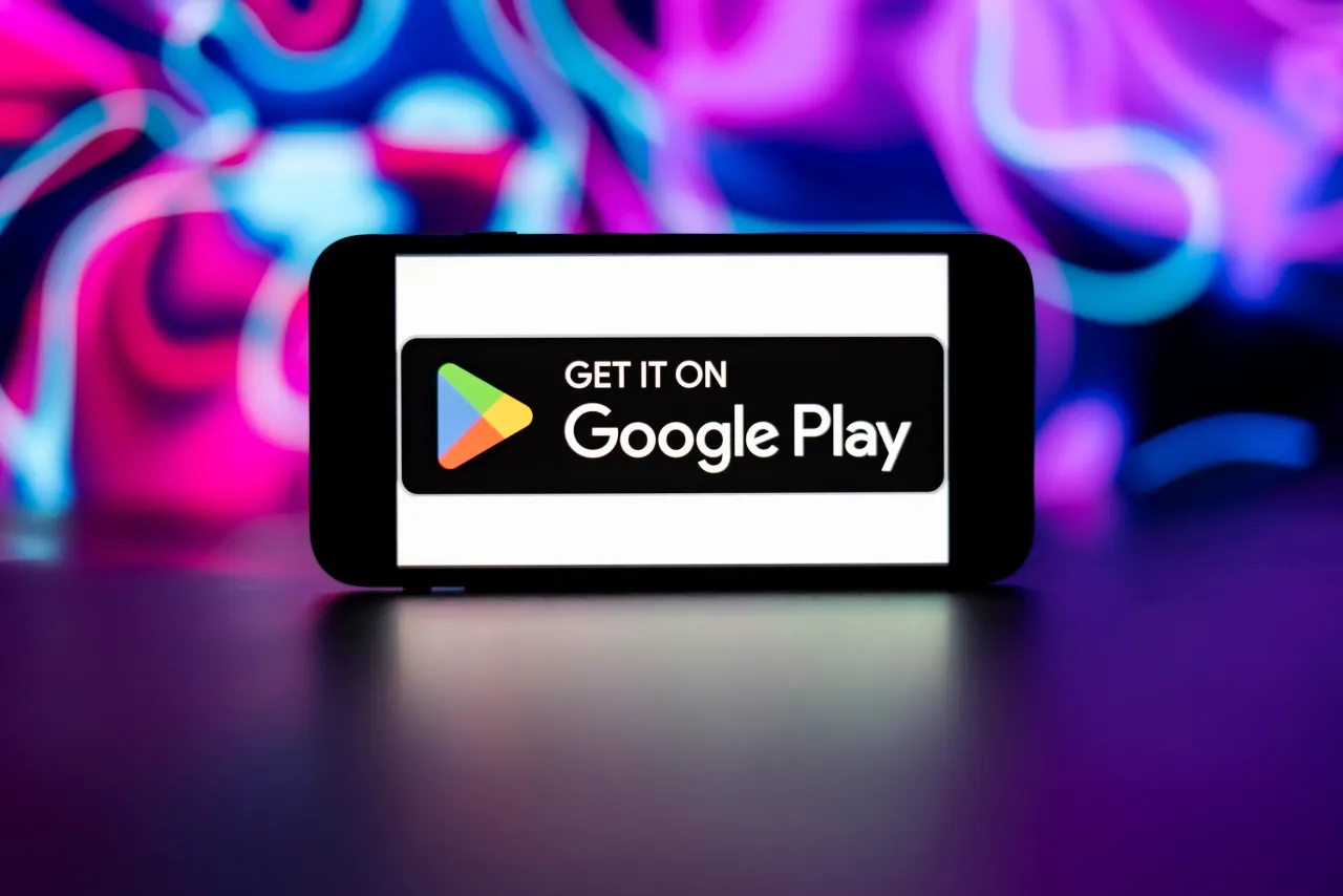 In this photo illustration, the Google play store logo is seen displayed on a mobile phone screen