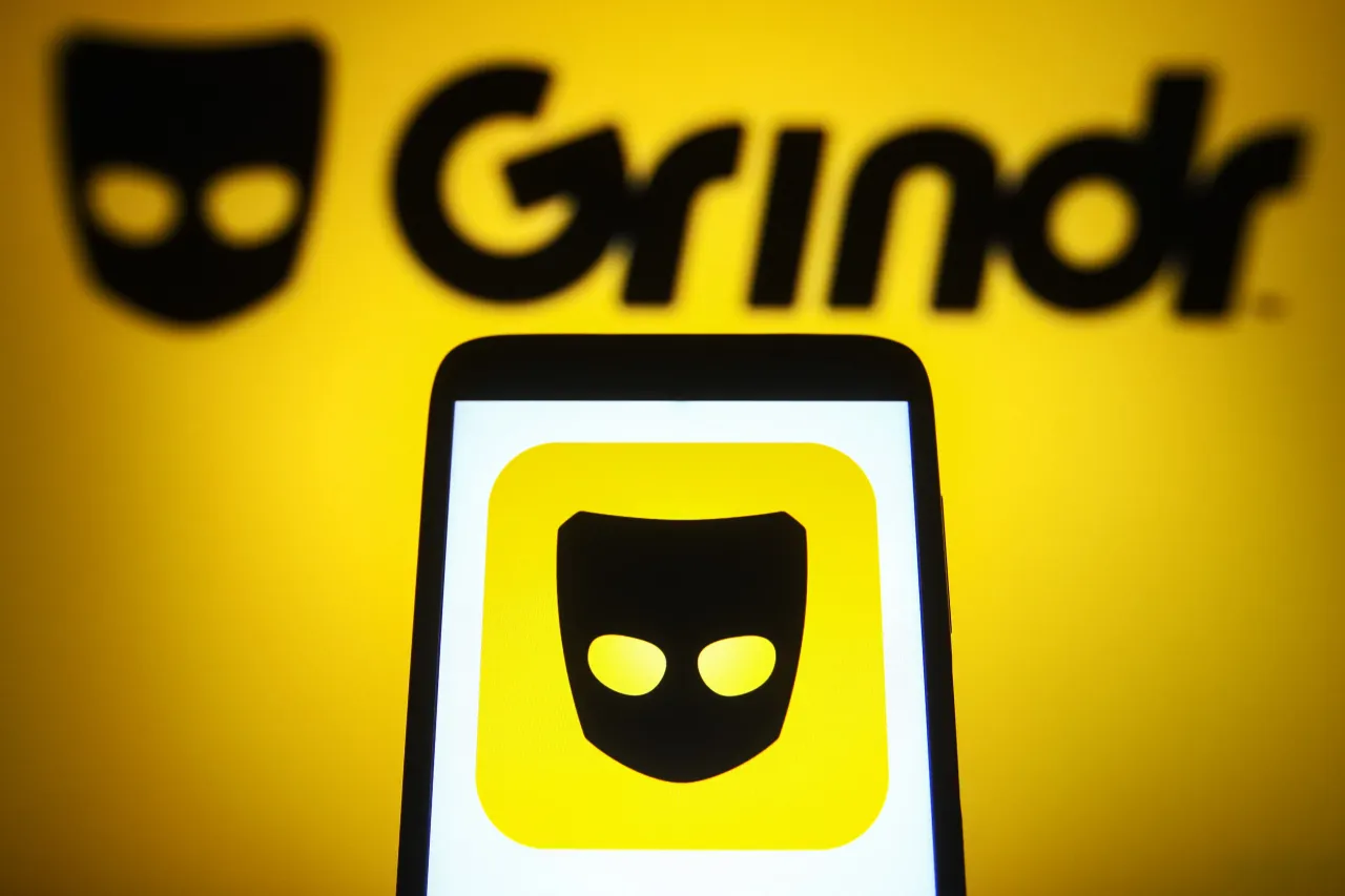 In this photo illustration a Grindr logo is seen on a smartphone and a pc screen. (Photo Illustration by Pavlo Gonchar/SOPA Images/LightRocket via Getty Images)