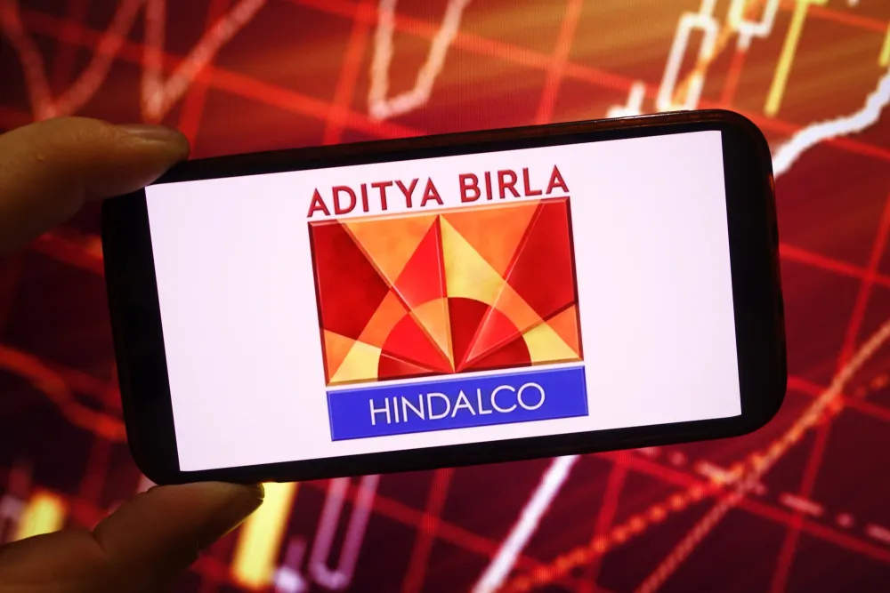 In this photo illustration, the Hindalco Industries company logo is seen displayed on a smartphone screen. (Photo Illustration by Piotr Swat/SOPA Images/LightRocket via Getty Images)