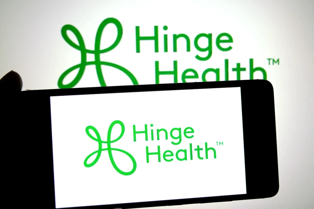 In this photo illustration, a Hinge Health logo is seen displayed on a smartphone and in the background. (Photo Illustration by Avishek Das/SOPA Images/LightRocket via Getty Images)