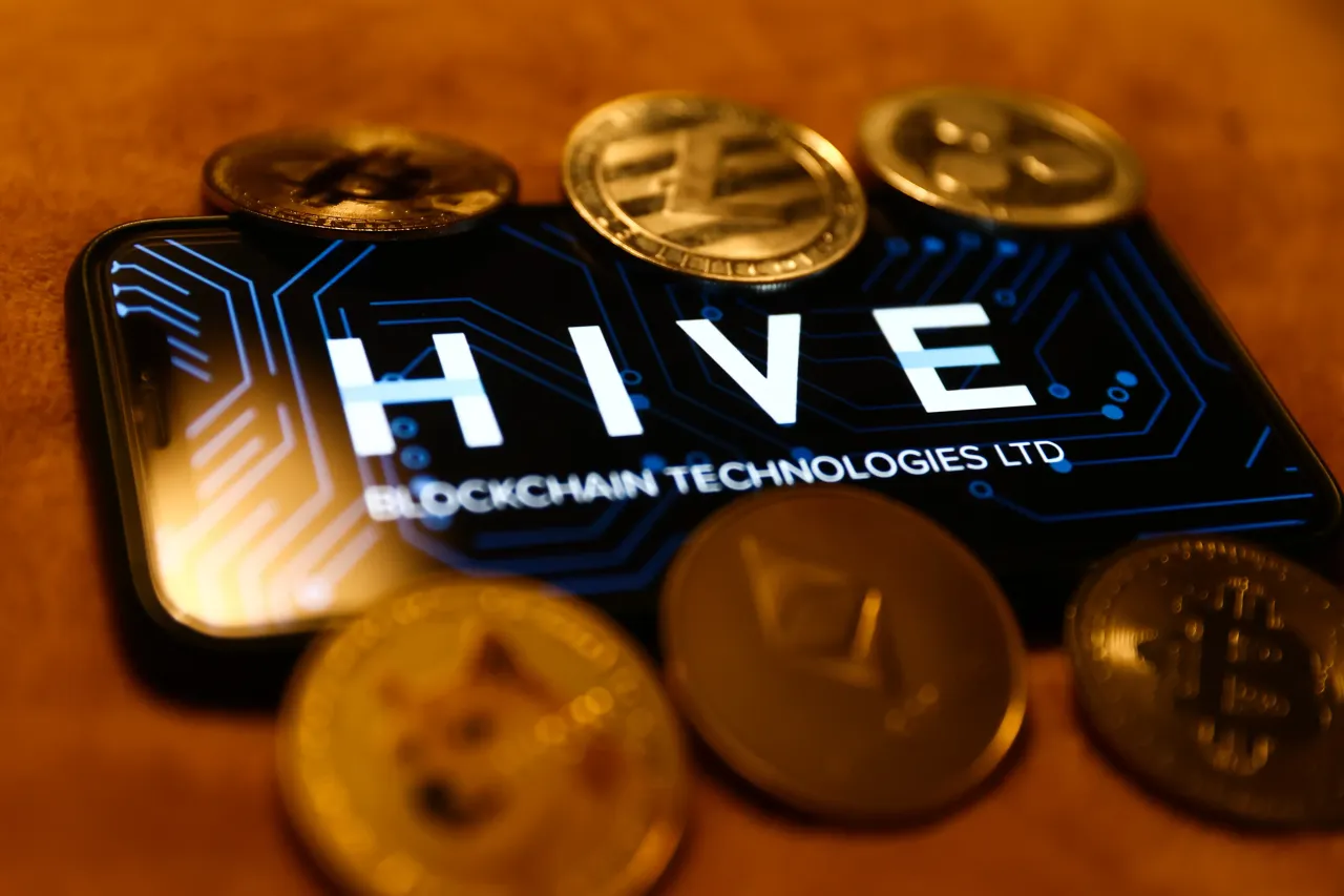 HIVE Blockchain Technologies Ltd logo displayed on a phone screen and representation of cryptocurrencies are seen in this illustration photo taken in Krakow, Poland on January 29, 2023. (Photo by Jakub Porzycki/NurPhoto via Getty Images)