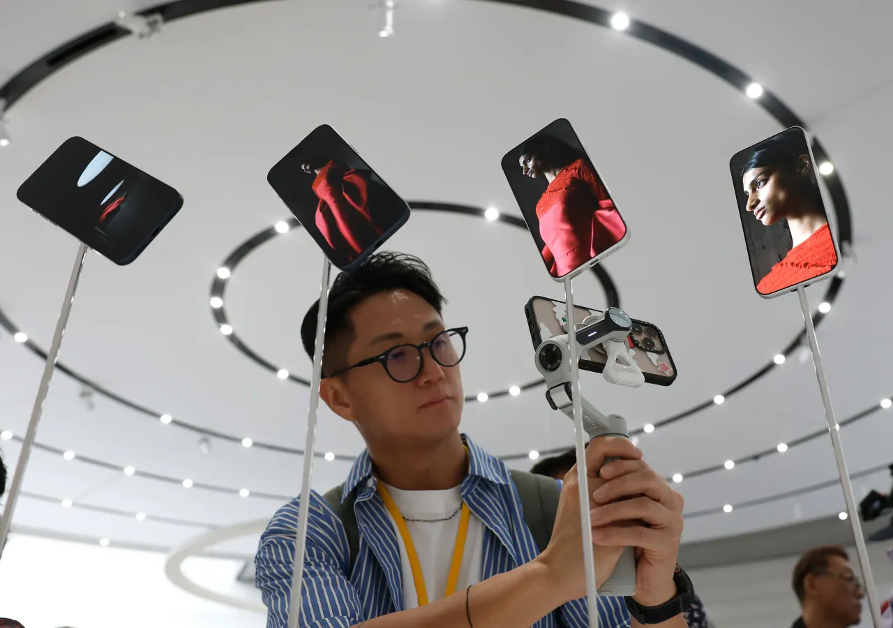 An attendee takes a video of a display of new Apple iPhone 17 Pros during an Apple special event at Apple headquarters on September 9, 2025 in Cupertino, California. 