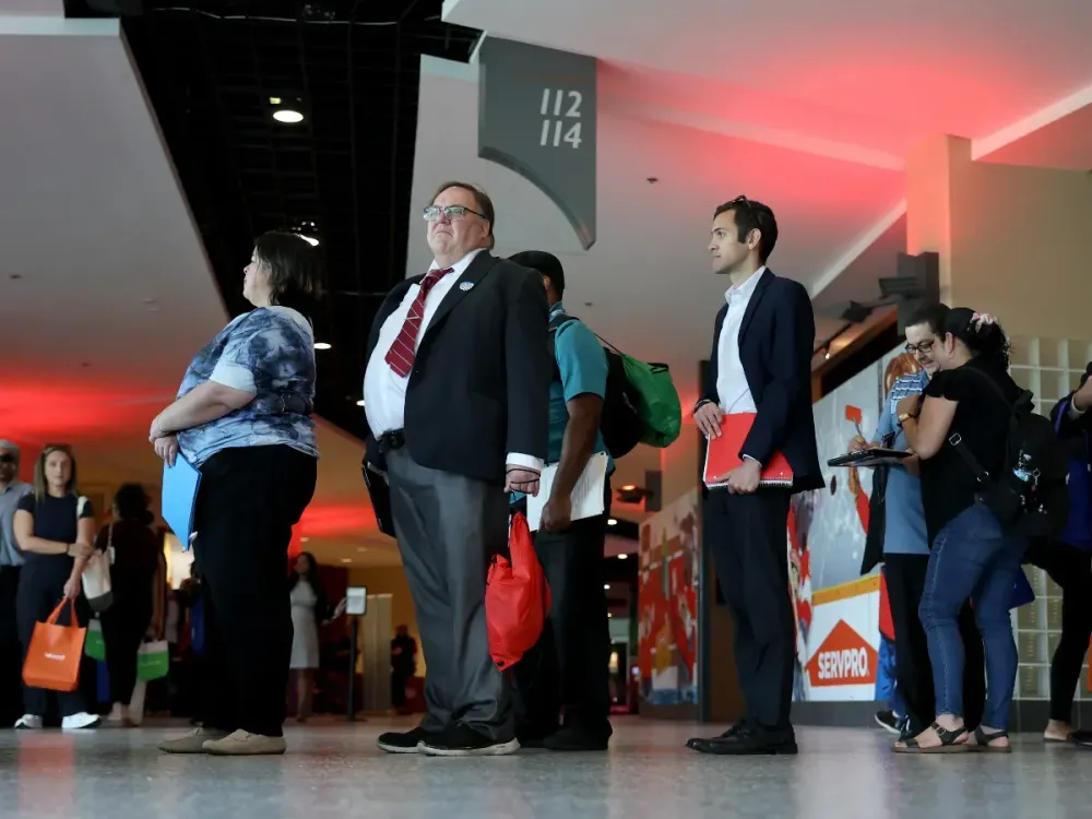 Job seekers stand in line at the Wyndham Destinations booth during the Mega JobNewsUSA South Florida Job Fair held in the Amerant Bank Arena on April 30, 2025. (Photo by Joe Raedle/Getty Images)