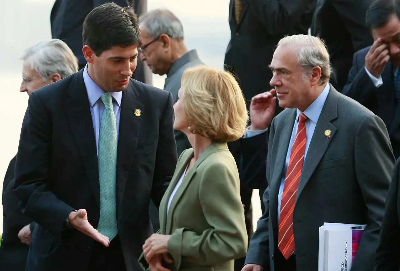 Kevin Warsh (L) talks with former EU Finance Minister Elena Salgado in 2010
