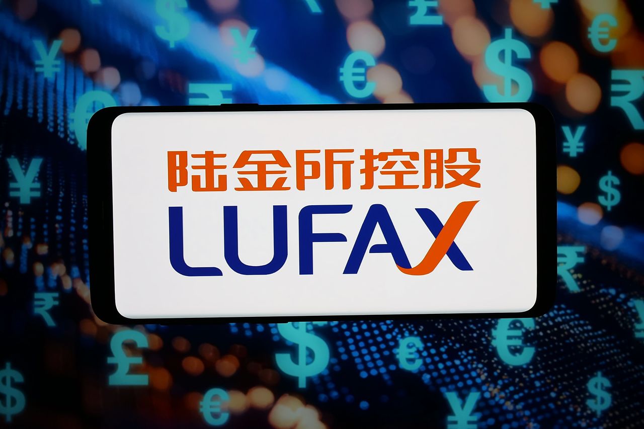 In this photo illustration, the Chinese financial company Lufax Holding Ltd. logo is seen displayed on a smartphone in front of abstract background on computer screen. (Photo Illustration by Timon Schneider/SOPA Images/LightRocket via Getty Images)