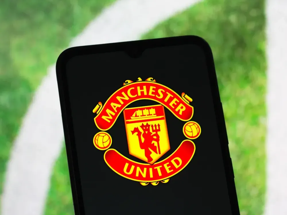 In this photo illustration, the Manchester United logo is seen displayed on a smartphone screen. (Photo Illustration by Thomas Fuller/SOPA Images/LightRocket via Getty Images)