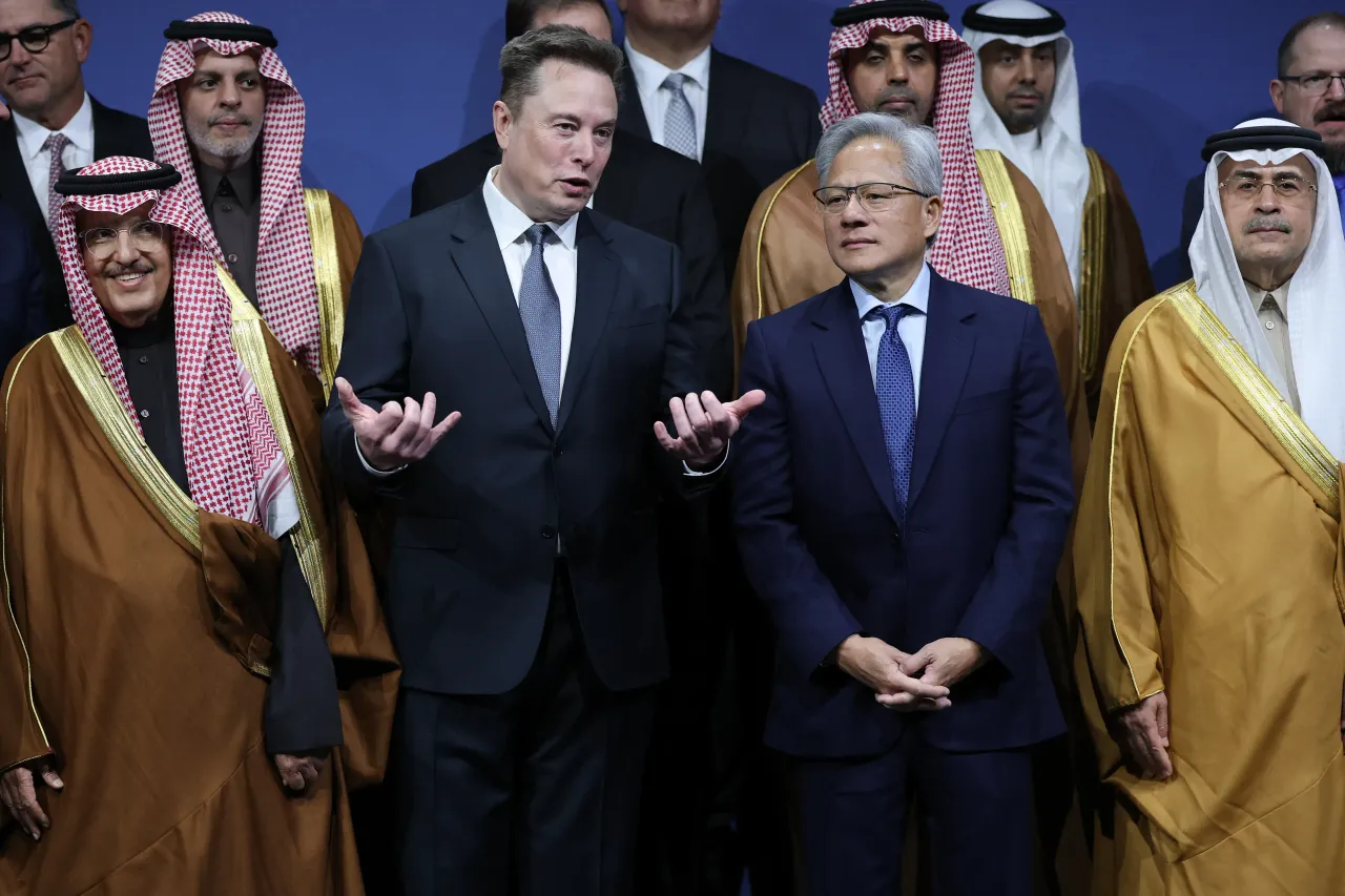Tesla CEO Elon Musk talks with Nvidia CEO Jensen Huang during the U.S.-Saudi Investment Forum at the Kennedy Center on November 19, 2025 in Washington, DC. (Photo by Win McNamee/Getty Images)