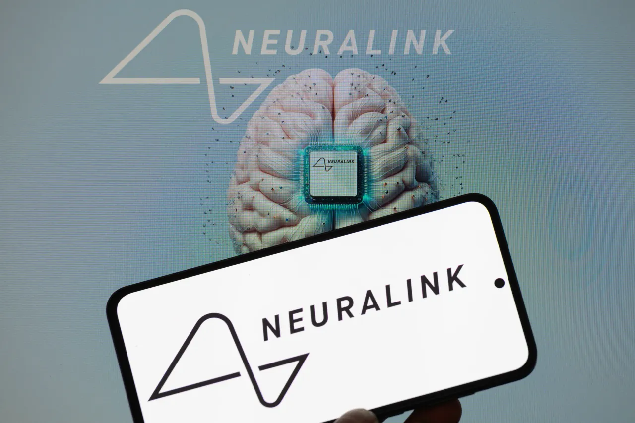The Neuralink logo is displayed on a mobile phone with Neuralink in the background in this photo illustration in Brussels, Belgium, on March 9, 2025. (Photo by Jonathan Raa/NurPhoto via Getty Images)