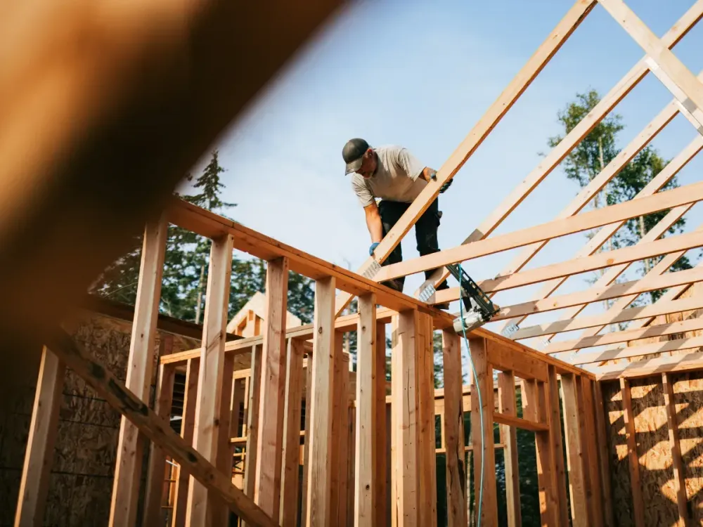 Representative image of workers building the frame of a new house project. (Photo by RyanJLane/Getty Images)