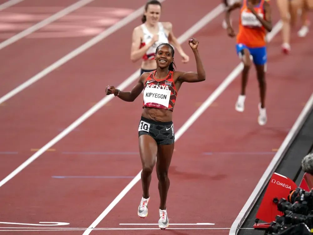 Faith Kipyegon celebrates as she crosses the finish line after winning the final of the women's 1,500-meters at the Tokyo 2020 Olympic Games. (Photo by Mike Egerton/PA Images via Getty Images)