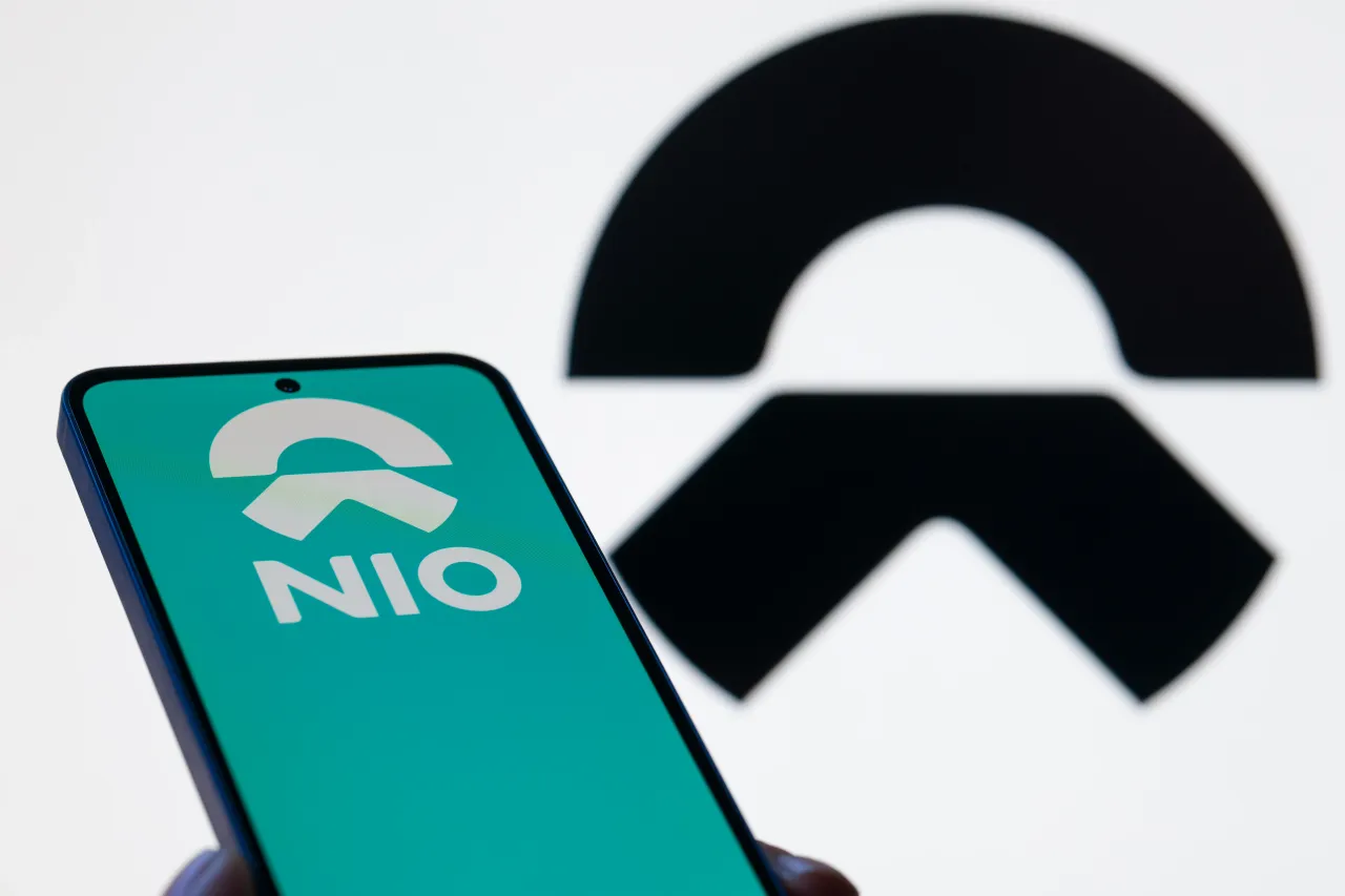 The NIO Ink logo is displayed on a mobile phone with the company branding seen in the background in this photo illustration in Brussels, Belgium, on November 9, 2025. (Photo by Jonathan Raa/NurPhoto via Getty Images)