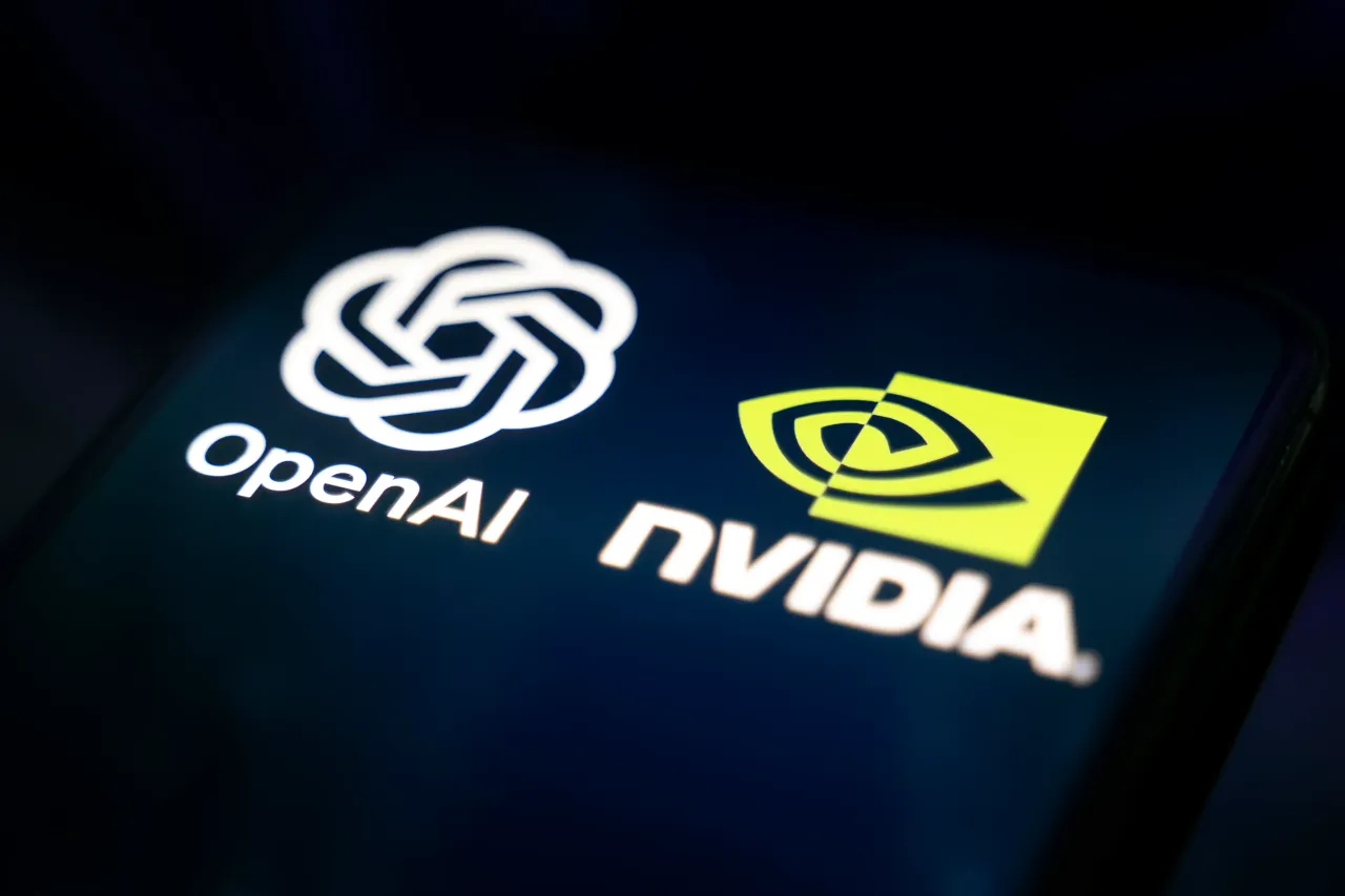 In this photo, the Nvidia and OpenAI logos appear on a smartphone reflecting an abstract illustration representing data flows. (Photo by Samuel Boivin/NurPhoto via Getty Images)