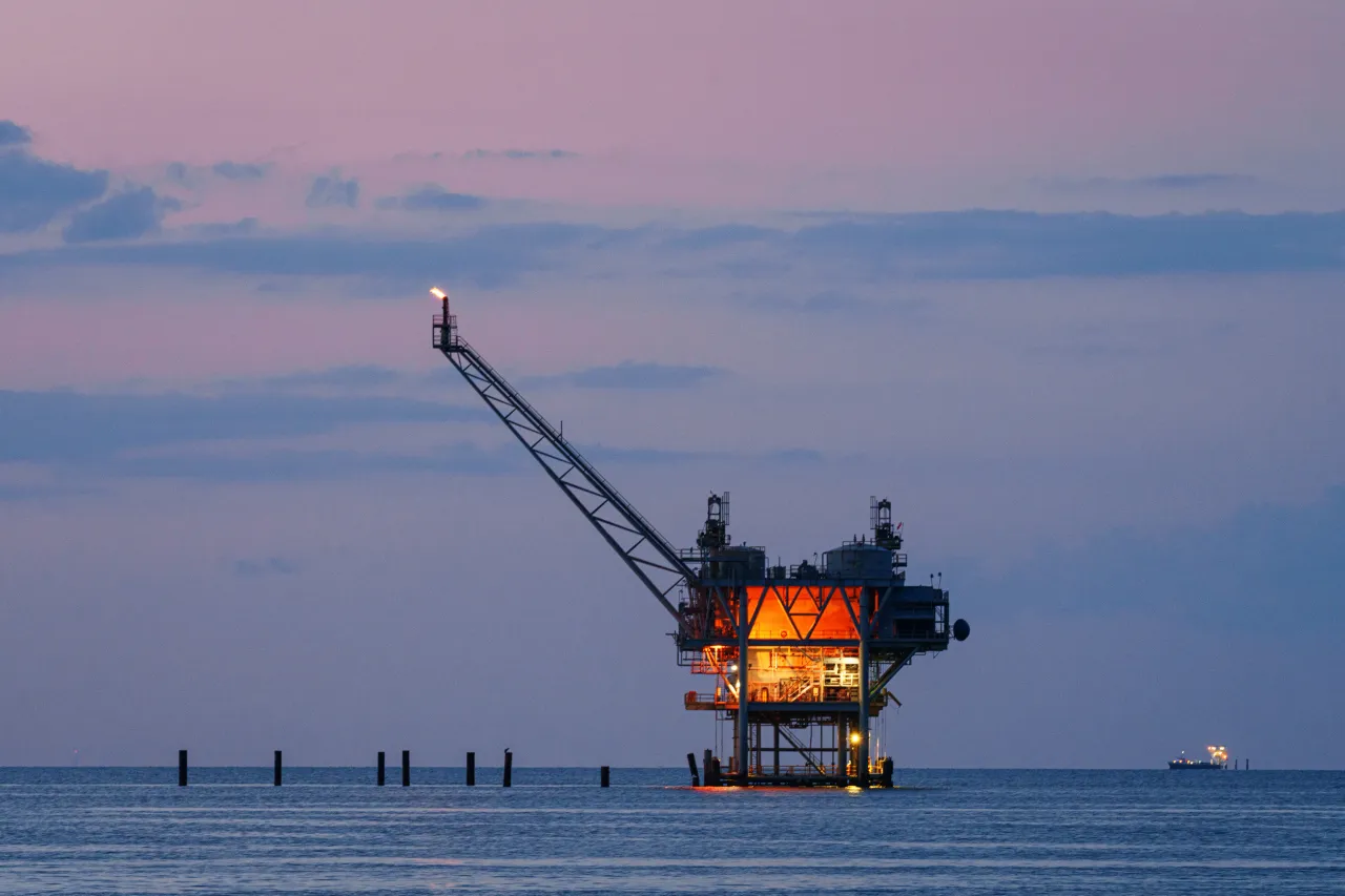 Dusk surrounds an offshore gas rig on May 10, 2024, near Fort Morgan, AL.