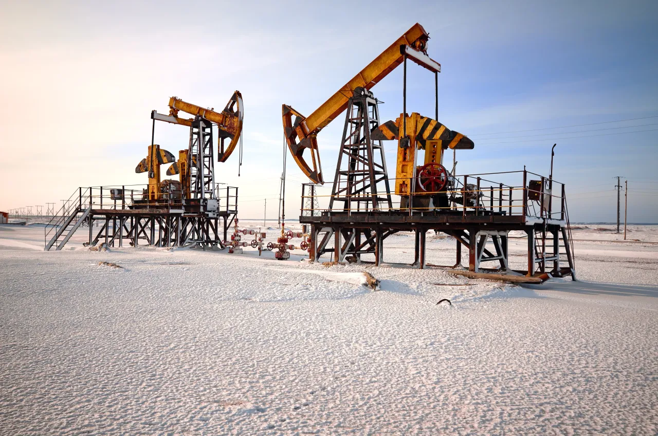 Oil pumpjack in snow.