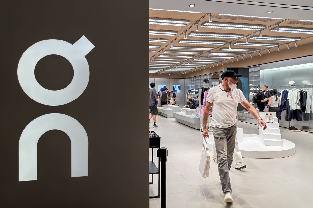 A customer carrying shopping bags walks out of an On Running retail store at a shopping mall on June 21, 2026, in Hong Kong, China. (Photo by Cheng Xin/Getty Images)