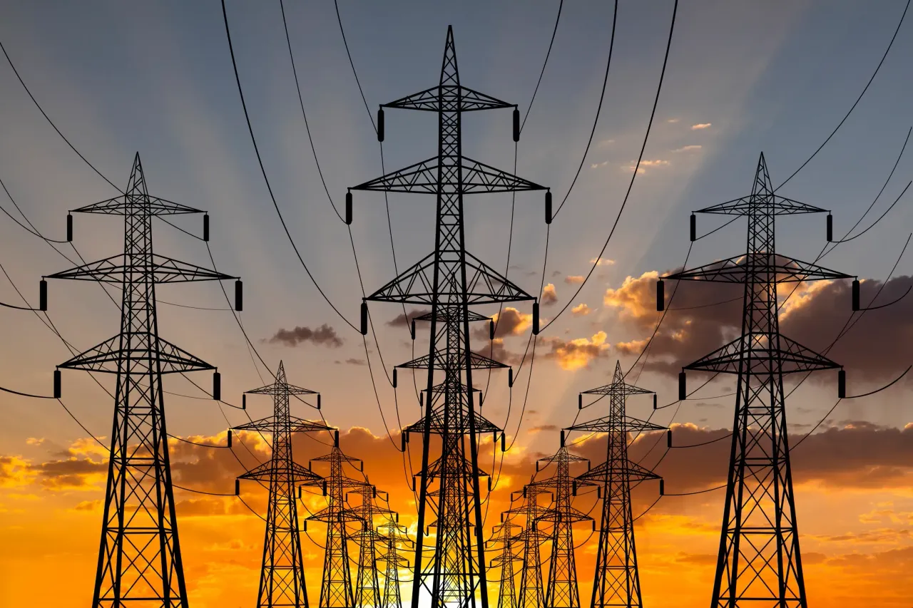High voltage towers at sunset background.