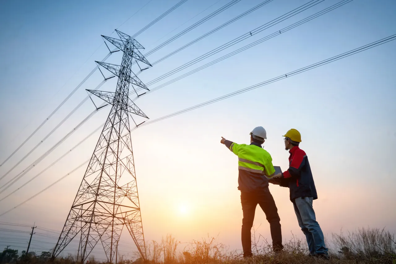 Electrical engineer working at the power station See the planning of electricity production at high voltage poles.
