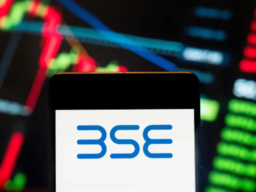 In this photo illustration, the India's Bombay Stock Exchange BSE logo seen displayed on a smartphone with an economic stock exchange index graph in the background. (Photo Illustration by Budrul Chukrut/SOPA Images/LightRocket via Getty Images)