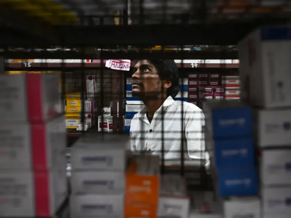 A worker sorts medicines in a wholesale medicine shop on April 03, 2025 in Allahabad, India. (Photo by Ritesh Shukla/Getty Images)