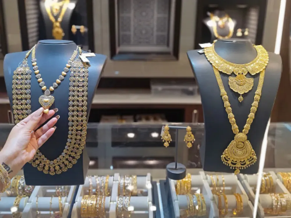 A woman checks a gold neckpiece at Kalyan Jewellers store in Mumbai.  (Photo by Ashish Vaishnav/SOPA Images/LightRocket via Getty Images)