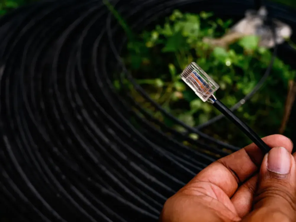 An employee of an Internet wired broadband service provider is providing internet connection through Internet Cable at Tehatta, West Bengal, India on 15 June 2021. (Photo by Soumyabrata Roy/NurPhoto via Getty Images)