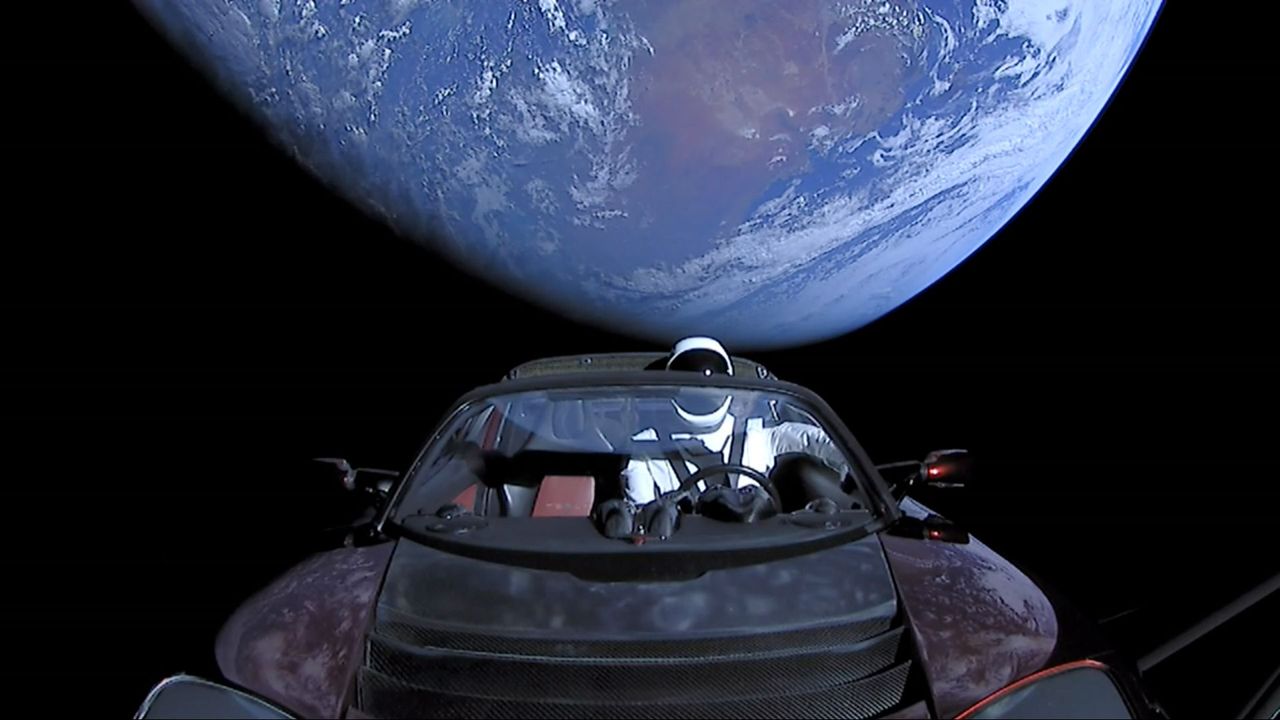 In this handout photo provided by SpaceX, a Tesla roadster launched from the Falcon Heavy rocket with a dummy driver named "Starman" heads towards Mars. (Photo by SpaceX via Getty Images)