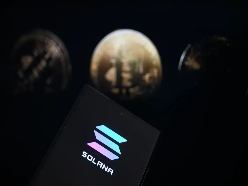 In this photo illustration, 'Solana' logo is displayed on mobile phone screen in front of the Bitcoin' coins in Ankara, Turkiye on March 07, 2025. (Photo by Harun Ozalp/Anadolu via Getty Images)