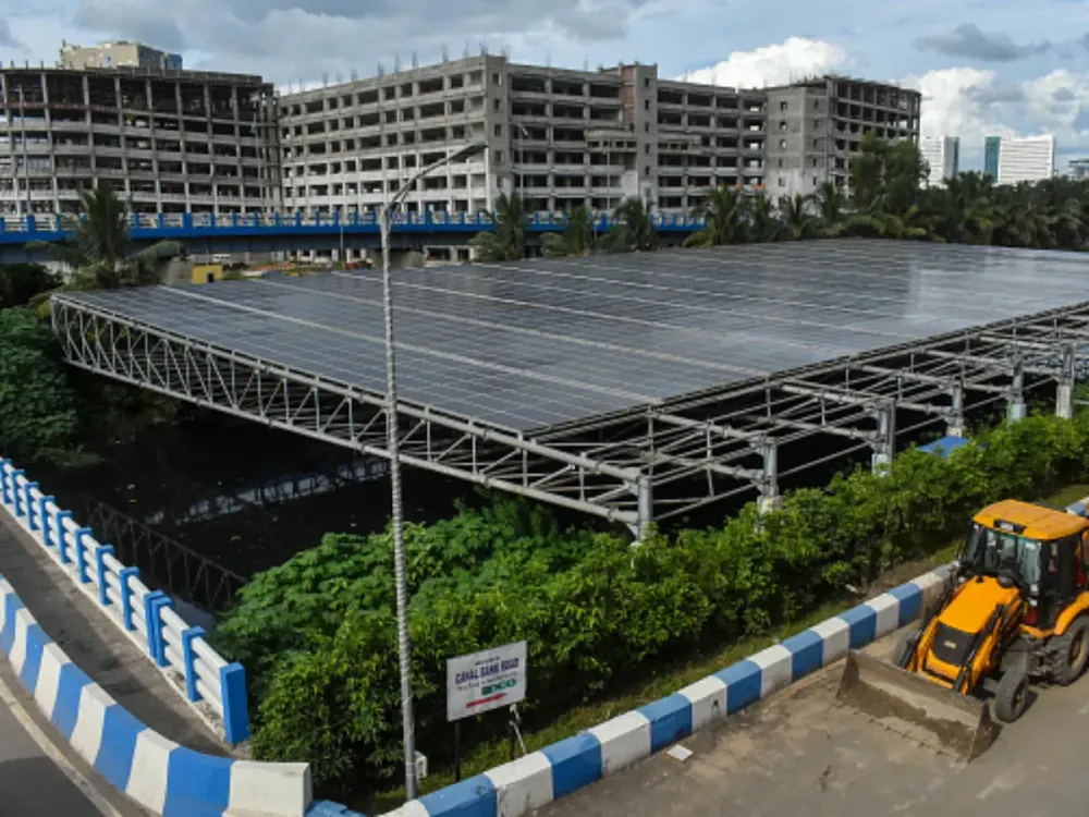 An array of solar panels is being seen over a sewage canal in Kolkata, India, on July 29, 2024. (Photo by Debarchan Chatterjee/NurPhoto via Getty Images)
