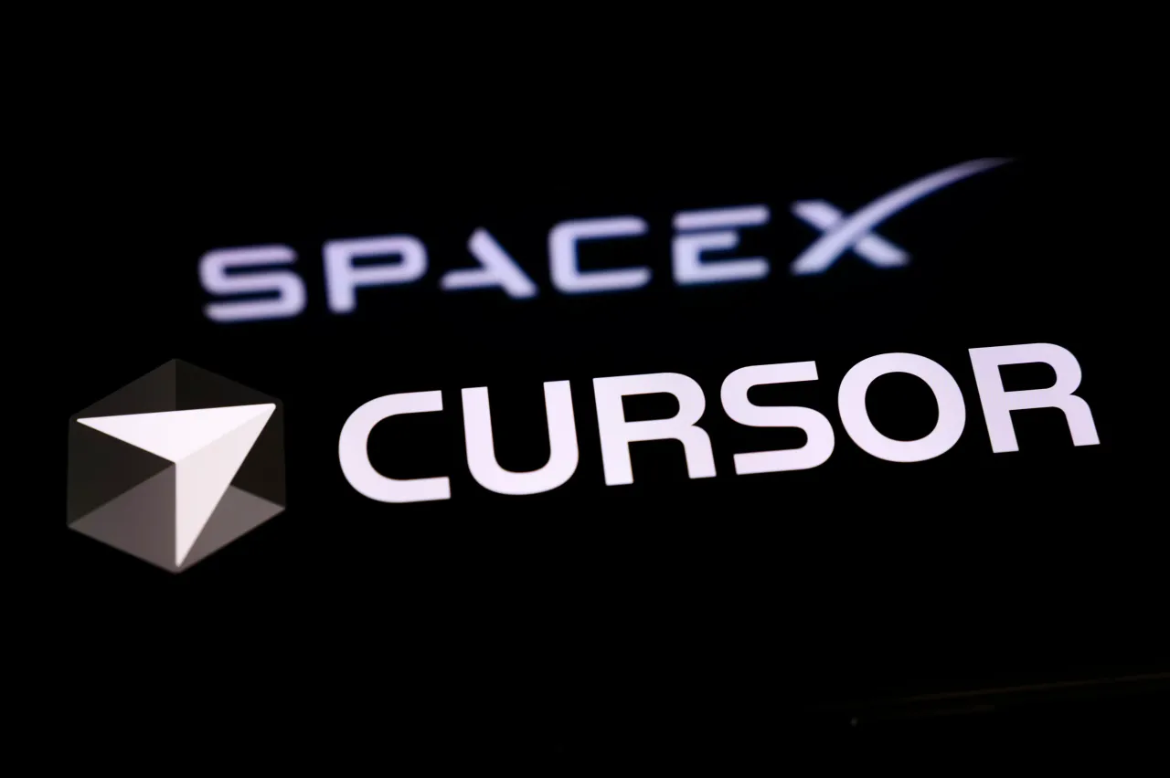 The Cursor logo is displayed on a smartphone screen placed on a reflective surface onto which the SpaceX logo is projected, in Creteil, France, on April 22, 2026. (Photo by Samuel Boivin/NurPhoto via Getty Images)