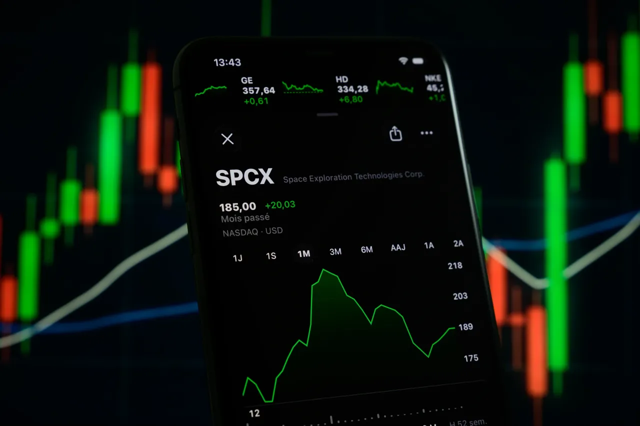 The SpaceX stock price is displayed on a smartphone screen with a stock market chart in the background, in Creteil, France, on June 19, 2026. (Photo by Samuel Boivin/NurPhoto via Getty Images)