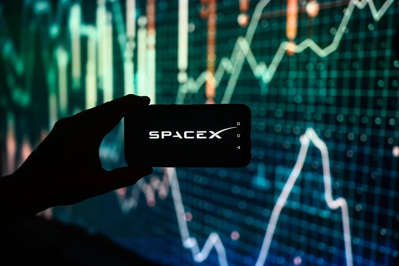 In this photo illustration a Space X logo is displayed on a smartphone with stock market percentages in the background. (Photo Illustration by Omar Marques/SOPA Images/LightRocket via Getty Images)