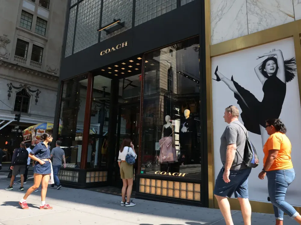 People walk past a Coach store on September 13, 2024 in New York City. (Photo by Michael M. Santiago/Getty Images)