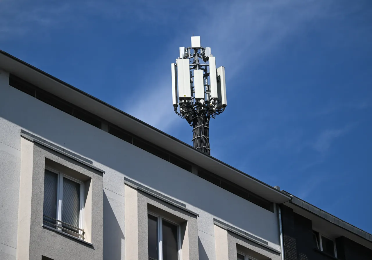 A mobile phone mast, also known as a mobile radio system, stands on a building in the city center