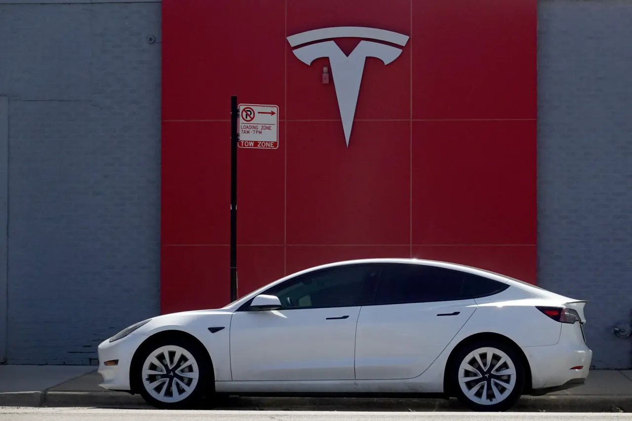 A Tesla car is parked in front of a dealership on March 28, 2022. (Photo by Scott Olson/Getty Images)