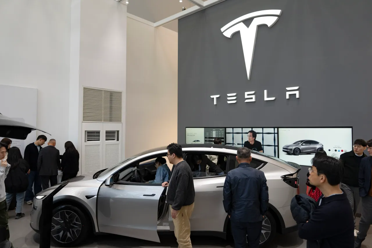 Visitors look at the new Tesla Model Y L (Long Wheelbase) at a showroom in Yeouido, Seoul, on April 8, 2026. (Photo by Chris Jung/NurPhoto via Getty Images)