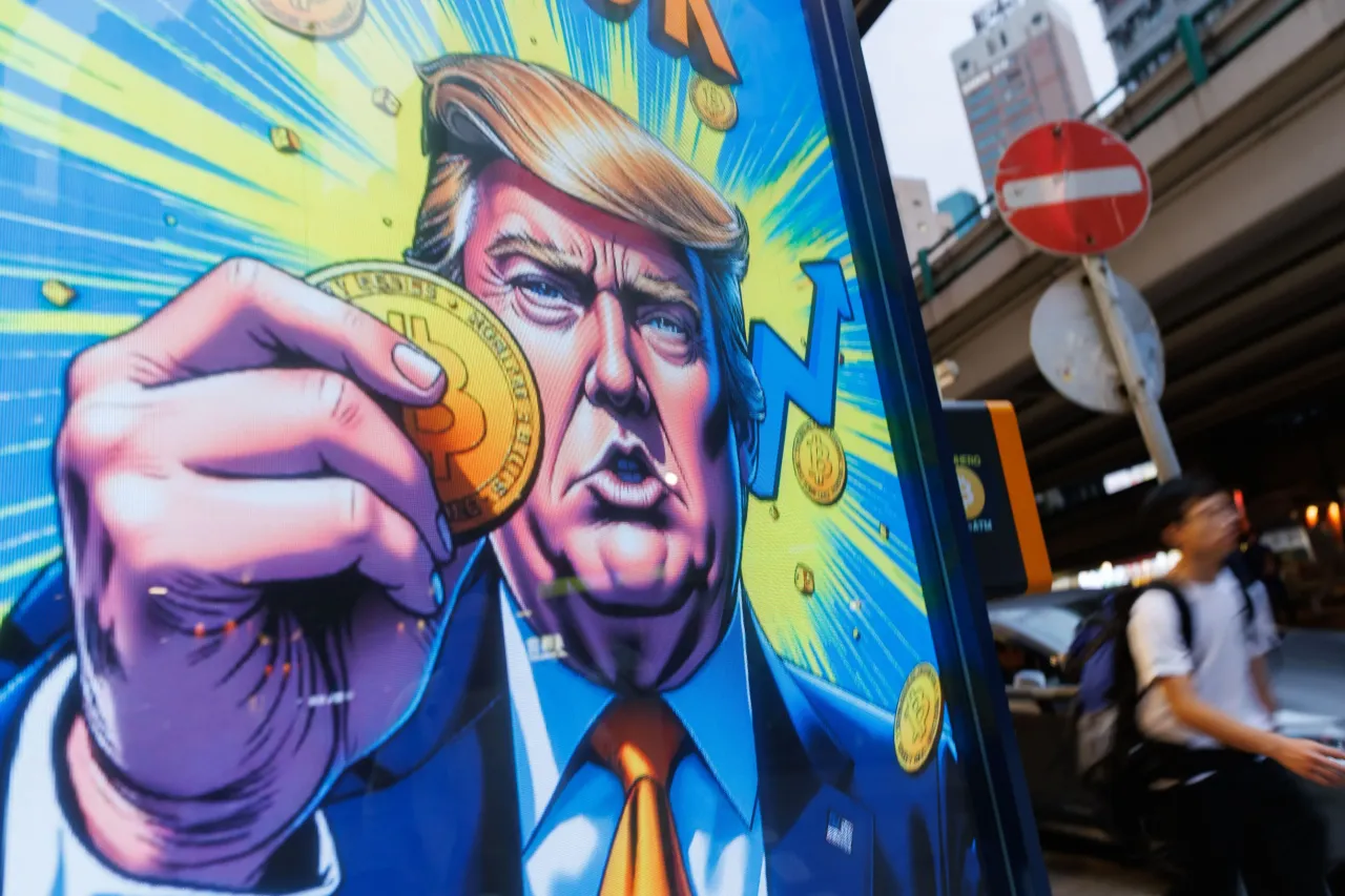 People walk past an advertisement feature Donald Trump with Bitcoin in Hong Kong on Sunday, April 6, 2025. (Photo by May James/SOPA Images/LightRocket via Getty Images)