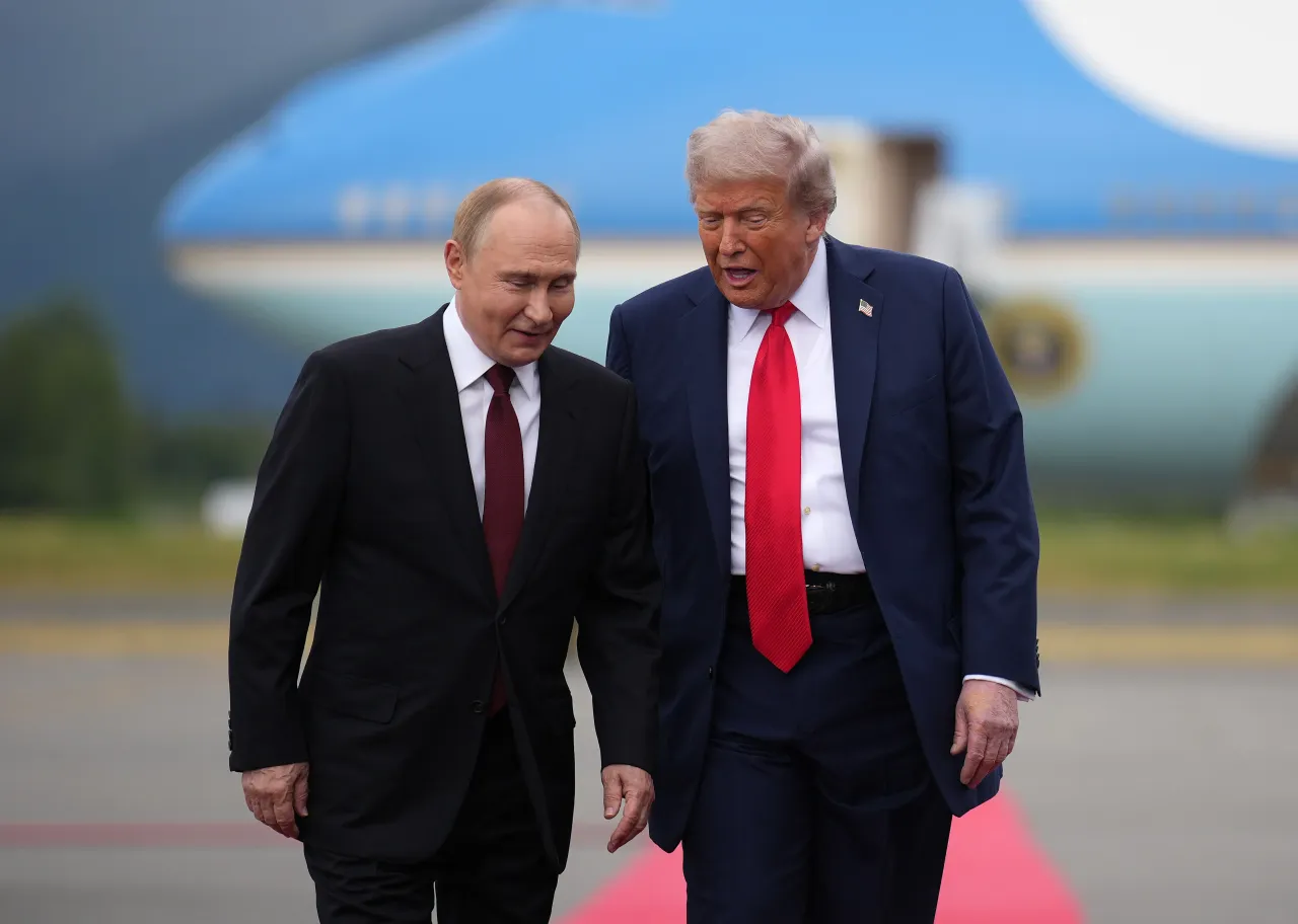 U.S. President Donald Trump (R) walks with Russian President Vladimir Putin as they arrives at Joint Base Elmendorf-Richardson. (Photo by Andrew Harnik/Getty Images)